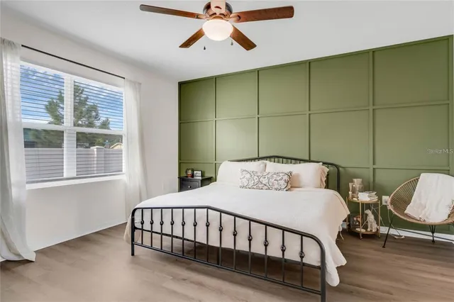 a bedroom with a bed window and a window