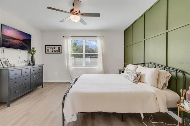 a bedroom with a bed and a flat screen tv