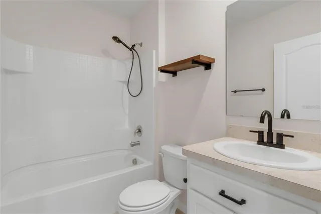 a bathroom with a sink a toilet and a bathtub