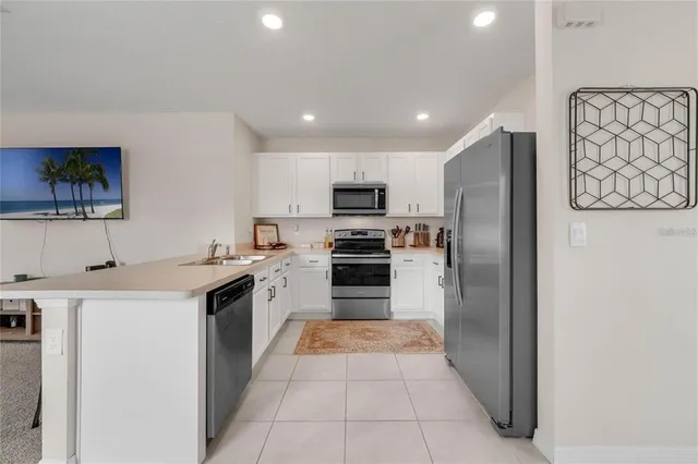 a kitchen with granite countertop a refrigerator and a stove
