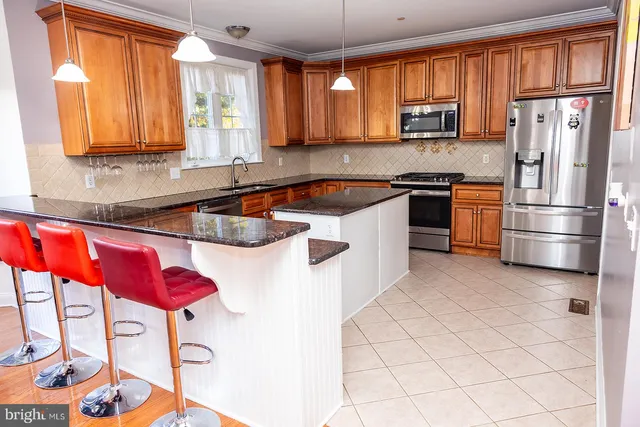 a kitchen with stainless steel appliances granite countertop a refrigerator sink and cabinets