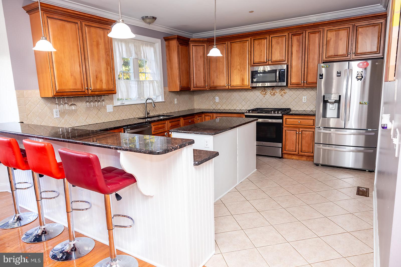 a kitchen with stainless steel appliances granite countertop a refrigerator sink and cabinets
