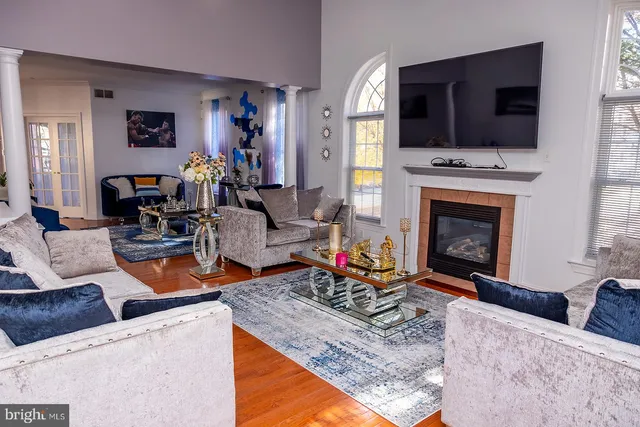 a living room with furniture a fireplace and a flat screen tv