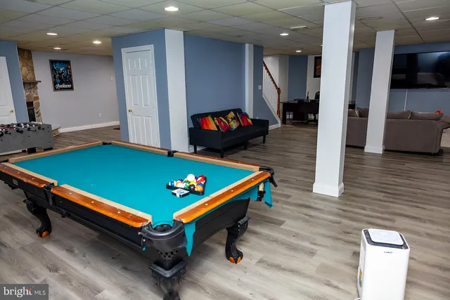 a room with pool table and windows