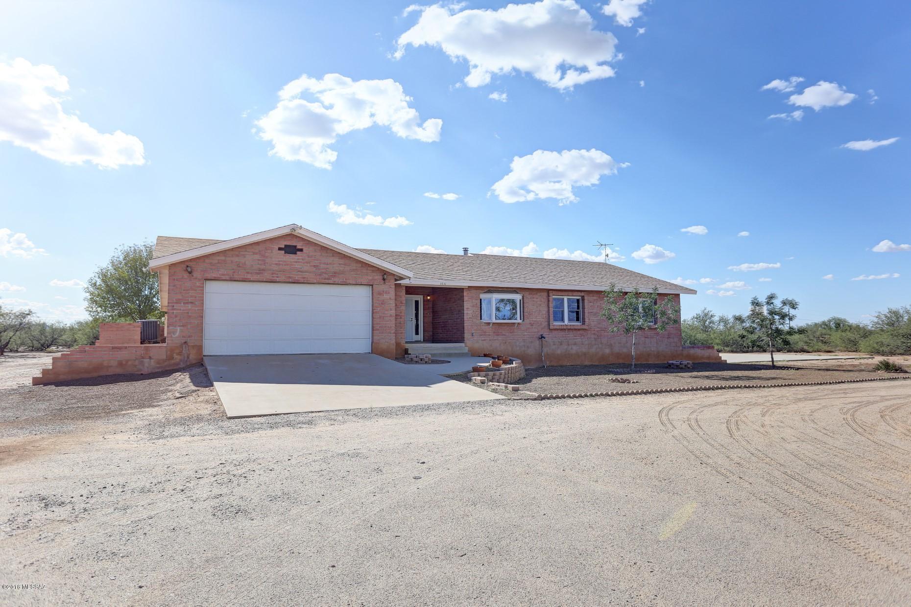 5851 South Avra Road Tucson, AZ 85735 - Photo 44 of 46 a view of a house with a yard and garage