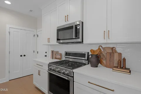a kitchen with granite countertop a stove and a microwave