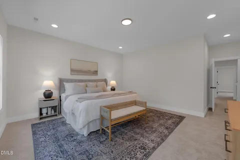 a bedroom with a bed and a rug