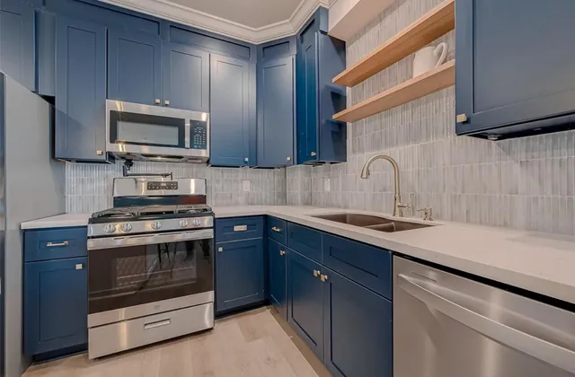 a kitchen with a sink stove and microwave