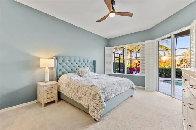 a bedroom with a large bed and a large window