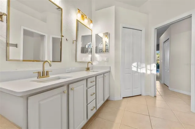 a spacious bathroom with a double vanity sink and a mirror
