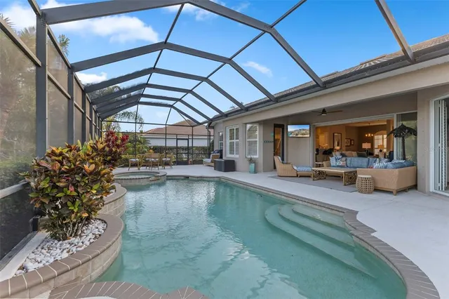 a view of a swimming pool with outdoor seating