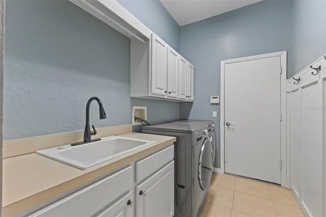 a kitchen with a sink cabinets and appliances