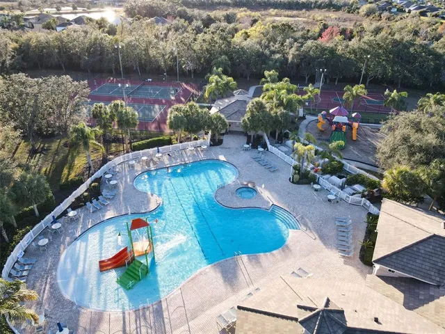 an aerial view of a house a yard and lake