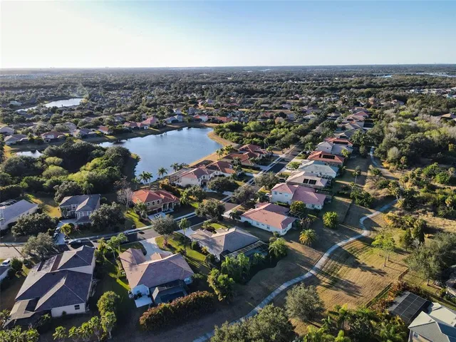 an aerial view of residential houses with city view