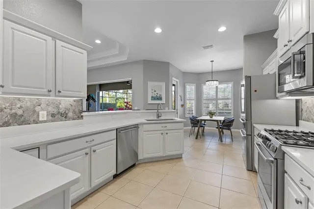 a kitchen with cabinets and chairs