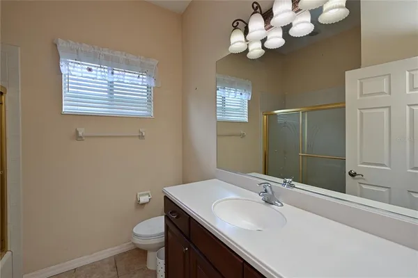 a bathroom with a sink a mirror and a toilet