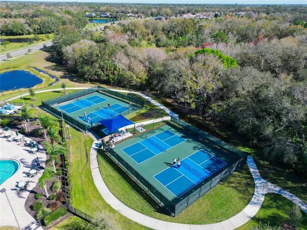 an aerial view of a backyard swimming pool patio and outdoor seating