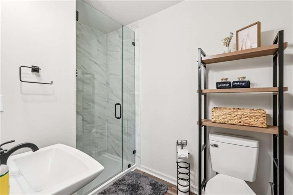 3465 Glen Road Decatur, GA 30032 - Photo 21 of 33 a bathroom with a toilet a sink and shower