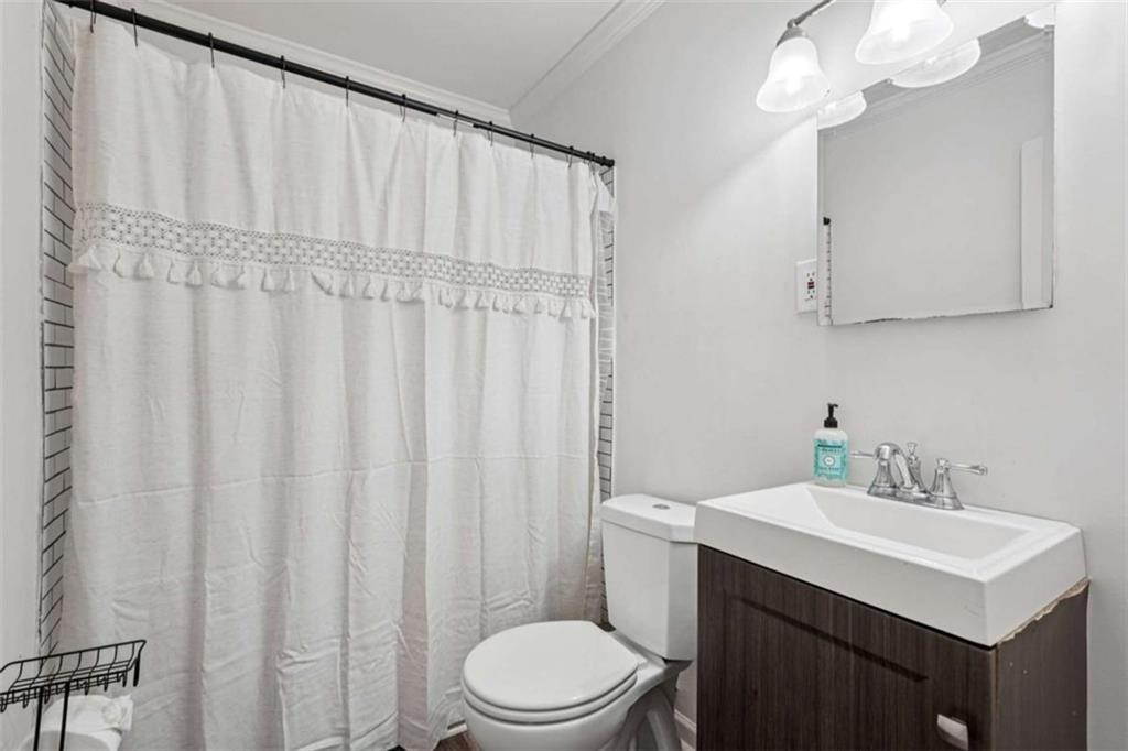 3465 Glen Road Decatur, GA 30032 - Photo 25 of 33 a bathroom with a sink a toilet and shower curtain