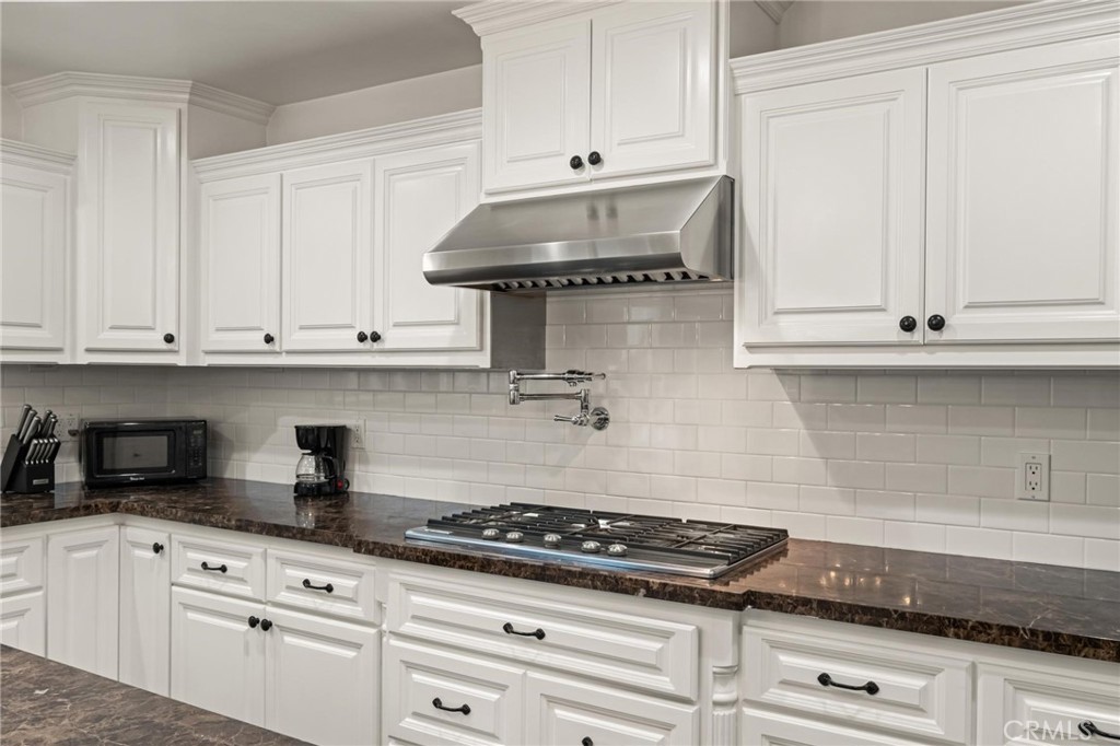 2219 Estribo Drive Rolling Hills Estates, CA 90274 - Photo 20 of 58 a kitchen with granite countertop white cabinets and white appliances