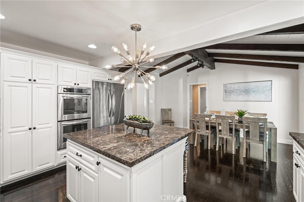 2219 Estribo Drive Rolling Hills Estates, CA 90274 - Photo 21 of 58 a kitchen with kitchen island a stove a table and chairs in it
