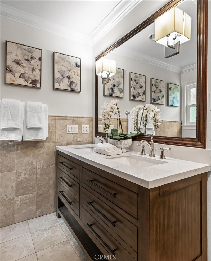 2219 Estribo Drive Rolling Hills Estates, CA 90274 - Photo 41 of 58 a bathroom with a sink a mirror and a painting on the wall