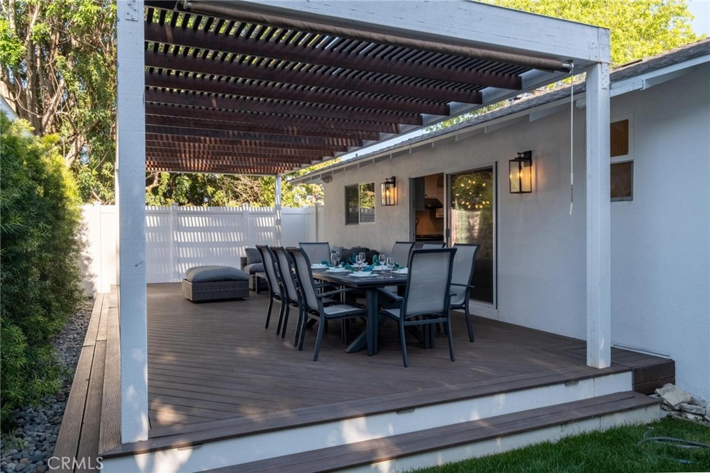 2219 Estribo Drive Rolling Hills Estates, CA 90274 - Photo 56 of 58 a view of a patio with table and chairs and floor to ceiling window with wooden floor