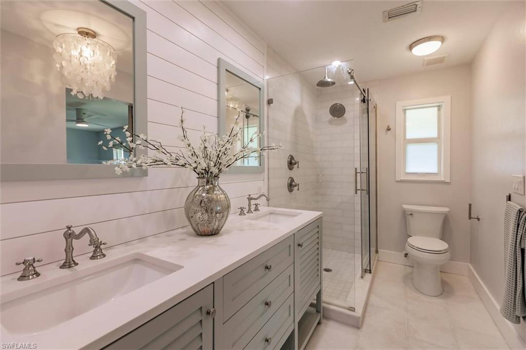 138 Riverview Road Fort Myers, FL 33905 - Photo 27 of 50 Full bathroom featuring a stall shower, a sink, and visible vents
