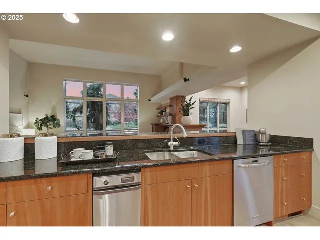 a kitchen with granite countertop a sink and cabinets