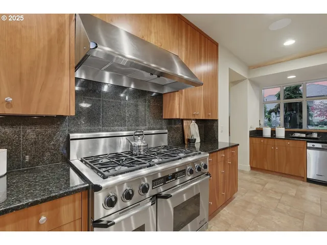 a kitchen with granite countertop a stove and a sink