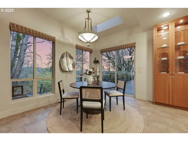 a view of a dining room with furniture wooden floor and chandelier