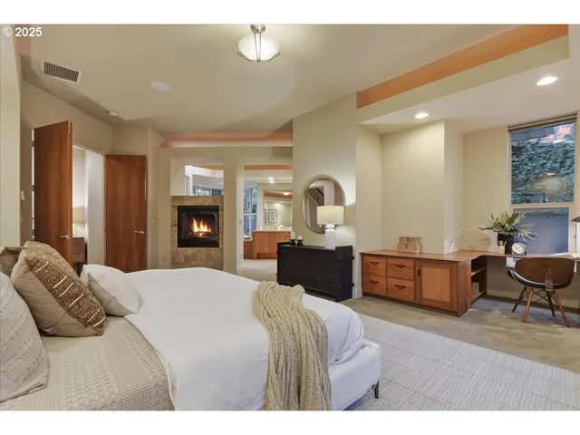 a bedroom with a bed and dresser with mirror