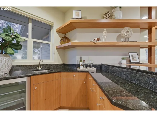 a view of a kitchen sink with cabinets