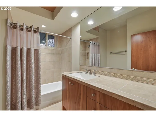 a bathroom with a sink a mirror and a shower
