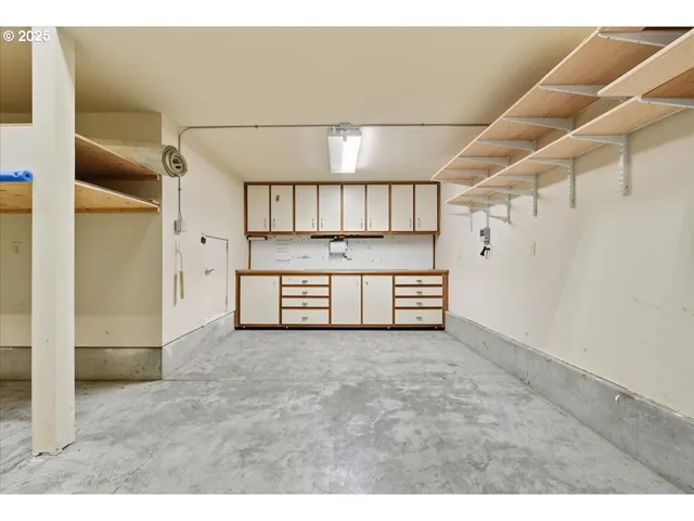 a view of a kitchen with refrigerator and cabinets
