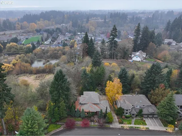 an aerial view of a house with a yard basket ball court and outdoor seating