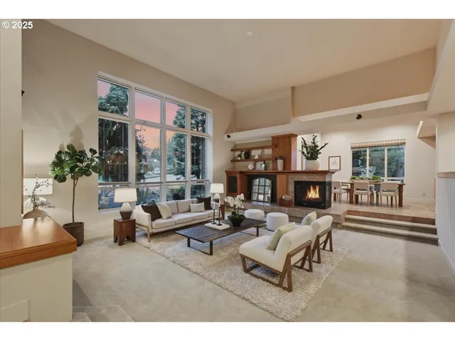 a living room with furniture and a floor to ceiling window