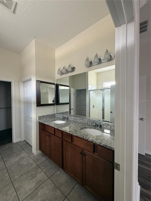 1809 Reflection Lane St. Cloud, FL 34771 - Photo 17 of 32 a bathroom with a granite countertop sink and a mirror