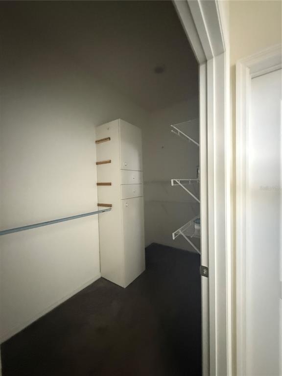 1809 Reflection Lane St. Cloud, FL 34771 - Photo 19 of 32 a view of walk in closet with empty racks