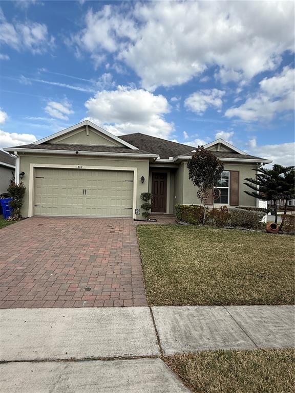 1809 Reflection Lane St. Cloud, FL 34771 - Photo 2 of 32 front view of a house with a dry yard