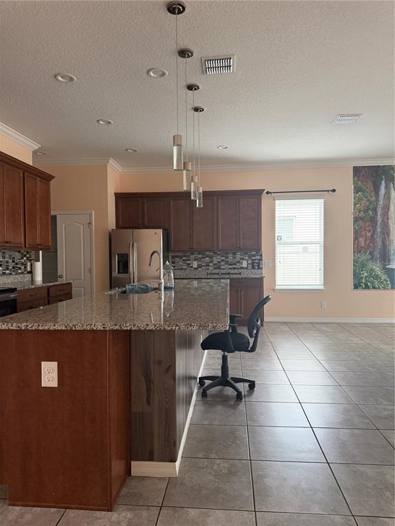 1809 Reflection Lane St. Cloud, FL 34771 - Photo 8 of 32 a kitchen with stainless steel appliances a sink a stove a refrigerator cabinets and a dining table