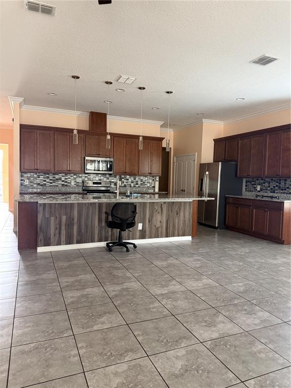 1809 Reflection Lane St. Cloud, FL 34771 - Photo 9 of 32 a view of kitchen with stainless steel appliances kitchen island granite countertop a stove and a sink with granite countertops