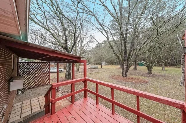 a view of trees and patio from the balcony