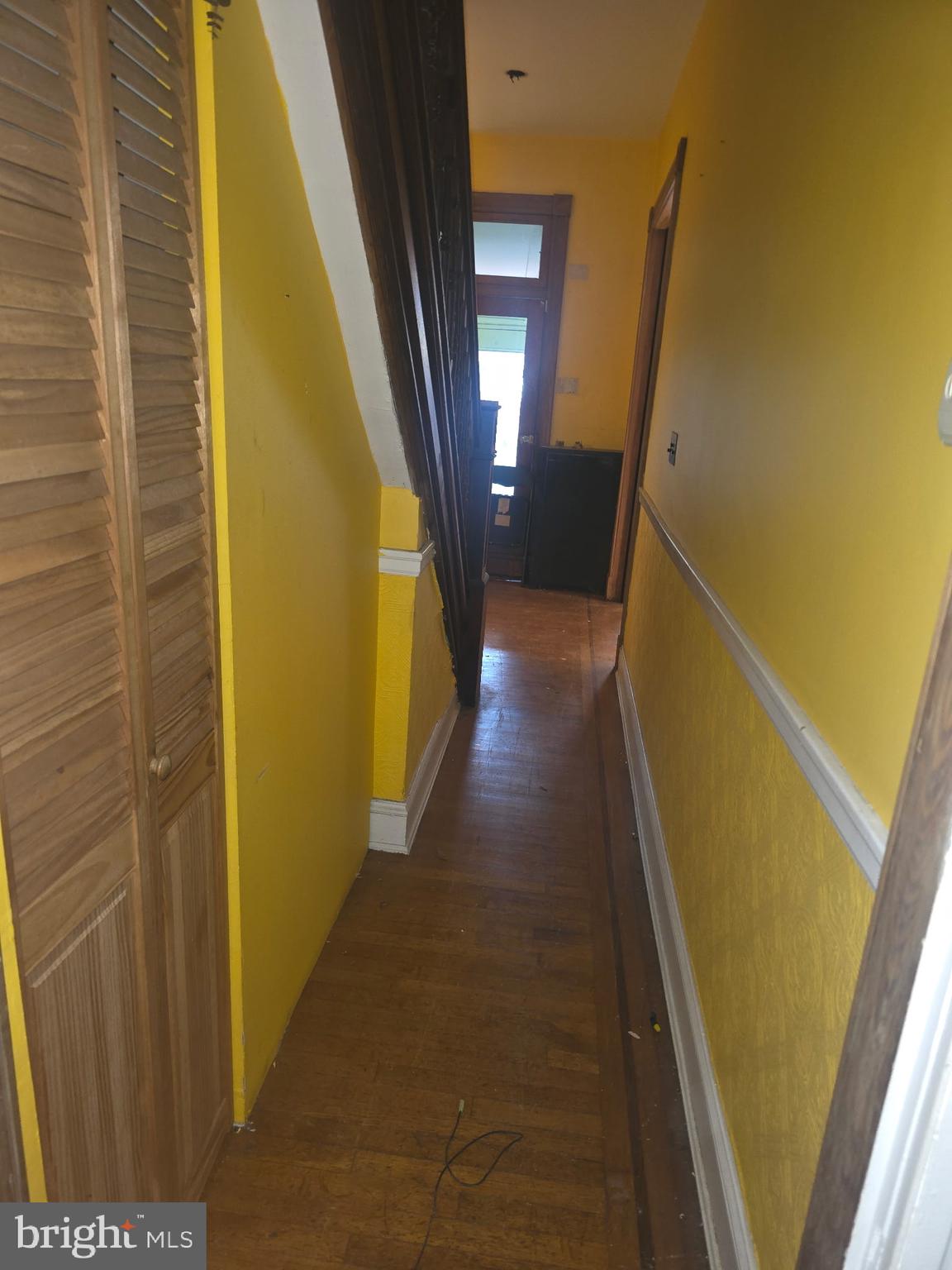 2721 North Calvert Street Baltimore, MD 21218 - Photo 5 of 29 a view of a hallway with wooden floor and door
