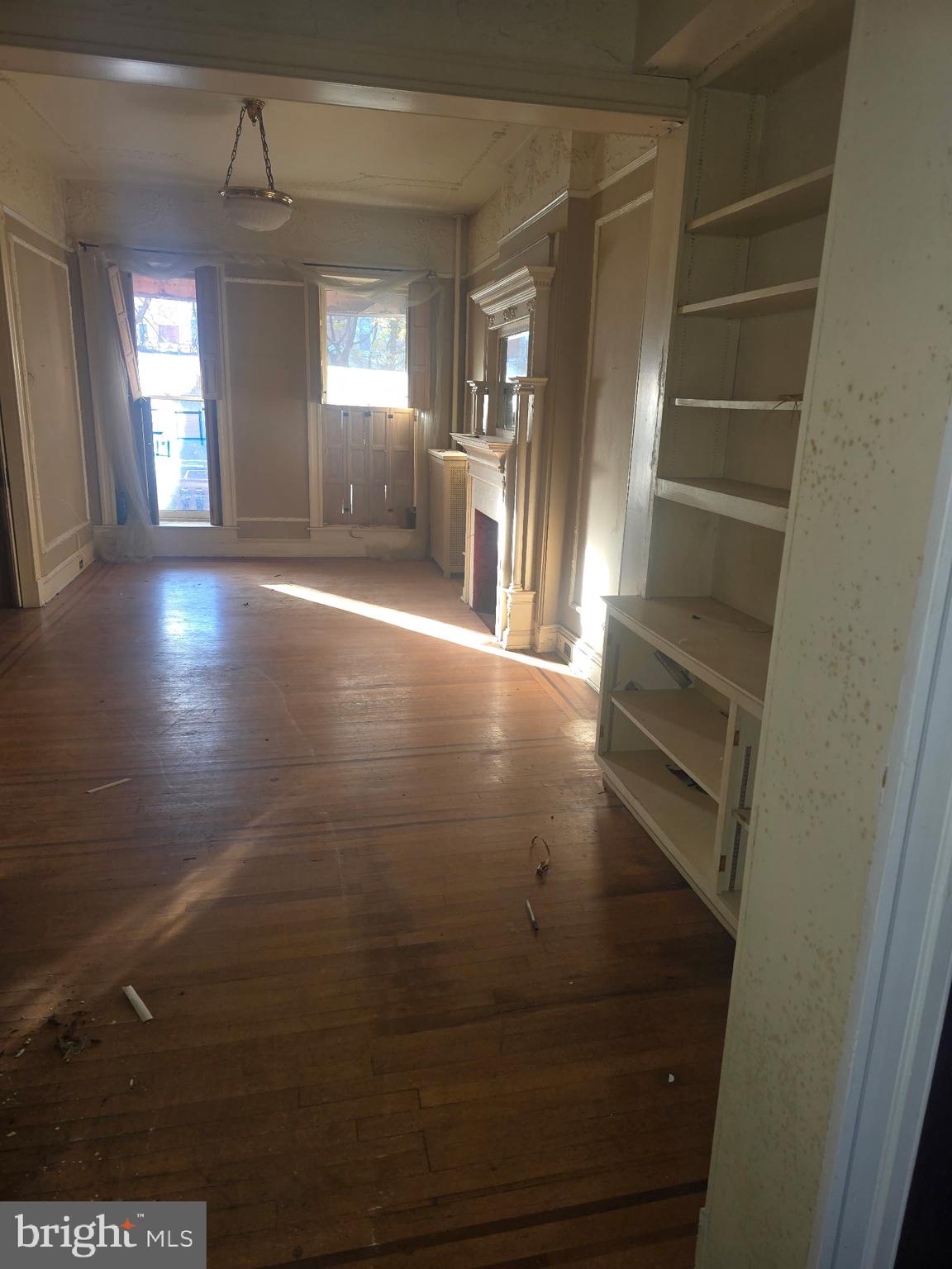 2721 North Calvert Street Baltimore, MD 21218 - Photo 9 of 29 an empty room with windows and entrance