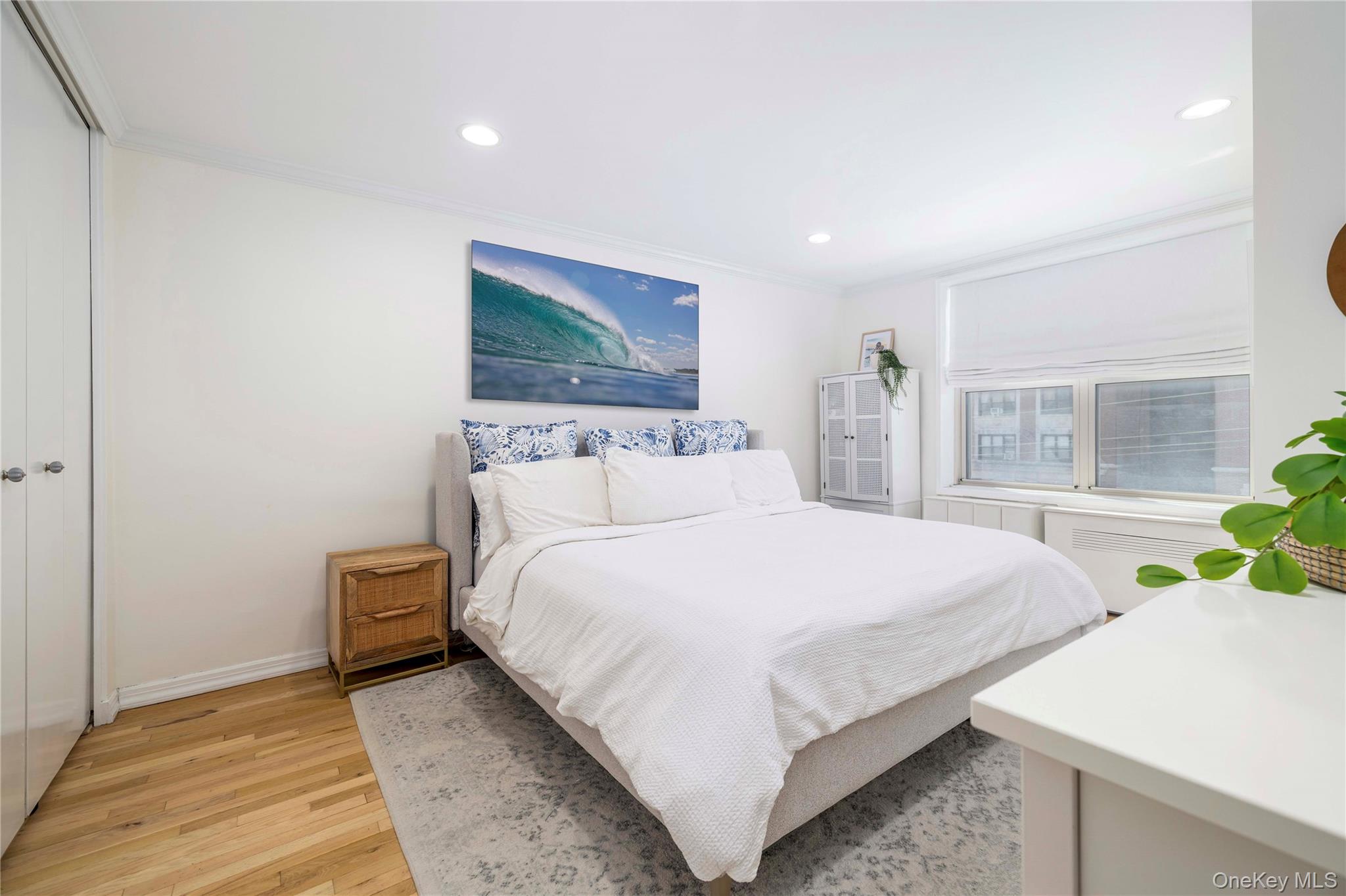 410 East Broadway, Unit 3E Long Beach, NY 11561 - Photo 11 of 23 a bedroom with a bed and large window