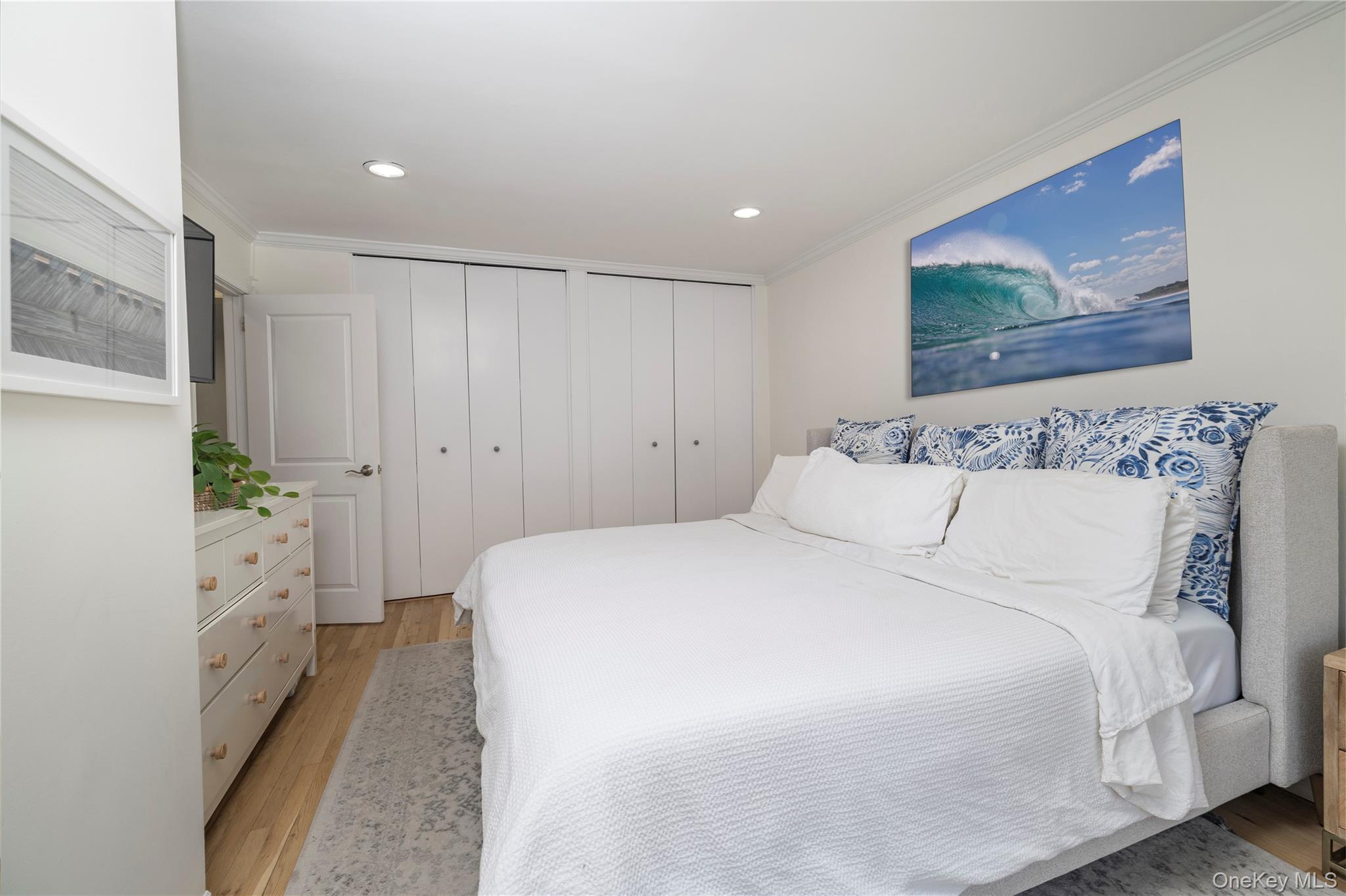 410 East Broadway, Unit 3E Long Beach, NY 11561 - Photo 12 of 23 a bed room with a bed and a painting