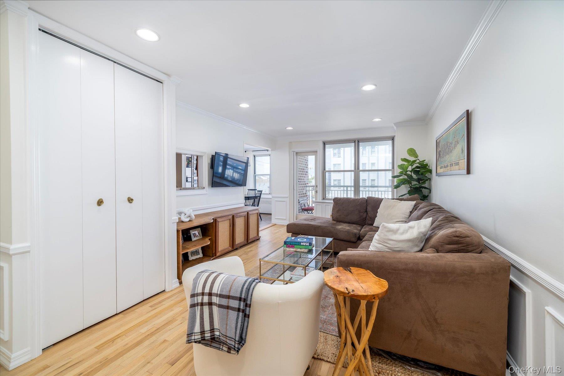 410 East Broadway, Unit 3E Long Beach, NY 11561 - Photo 2 of 23 a living room with furniture and a flat screen tv