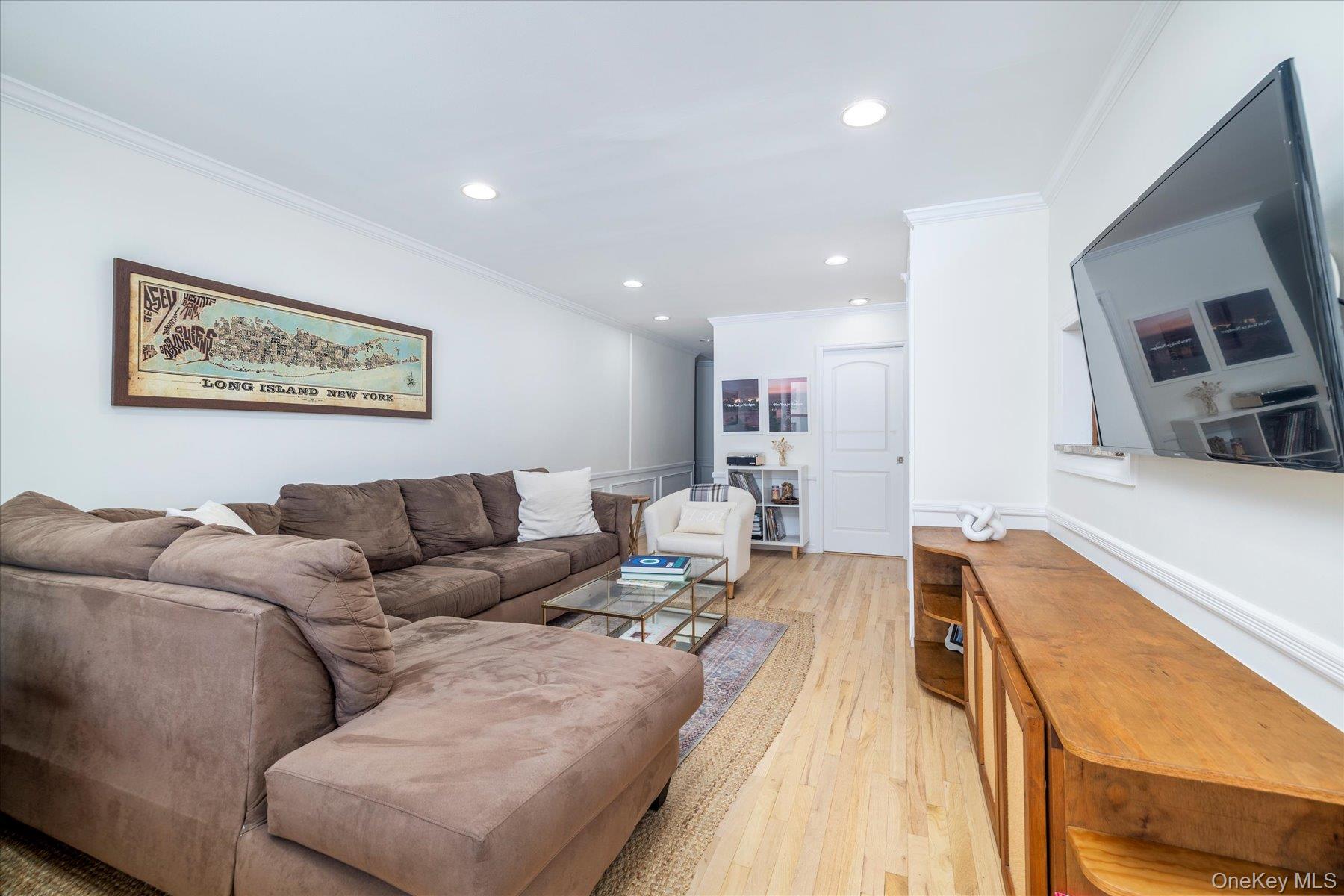 410 East Broadway, Unit 3E Long Beach, NY 11561 - Photo 4 of 23 a living room with furniture and a flat screen tv