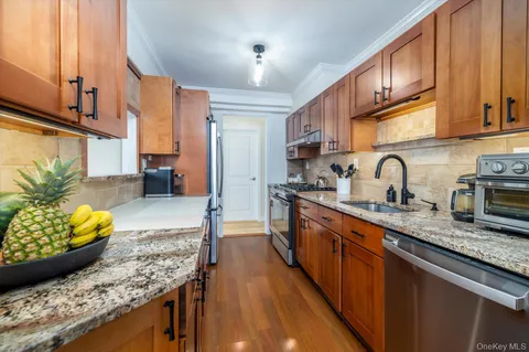 a kitchen with stainless steel appliances granite countertop a sink stove and cabinets